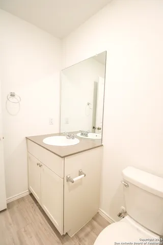 a bathroom with a sink a toilet and mirror