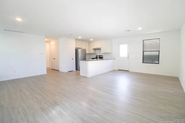 a view of a kitchen with a sink and a refrigerator