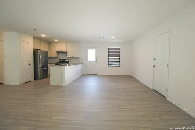a view of a kitchen with a sink and a refrigerator