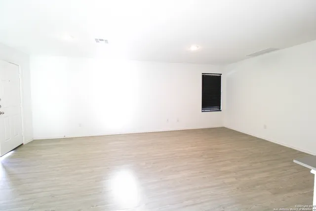 a view of a room with wooden floor