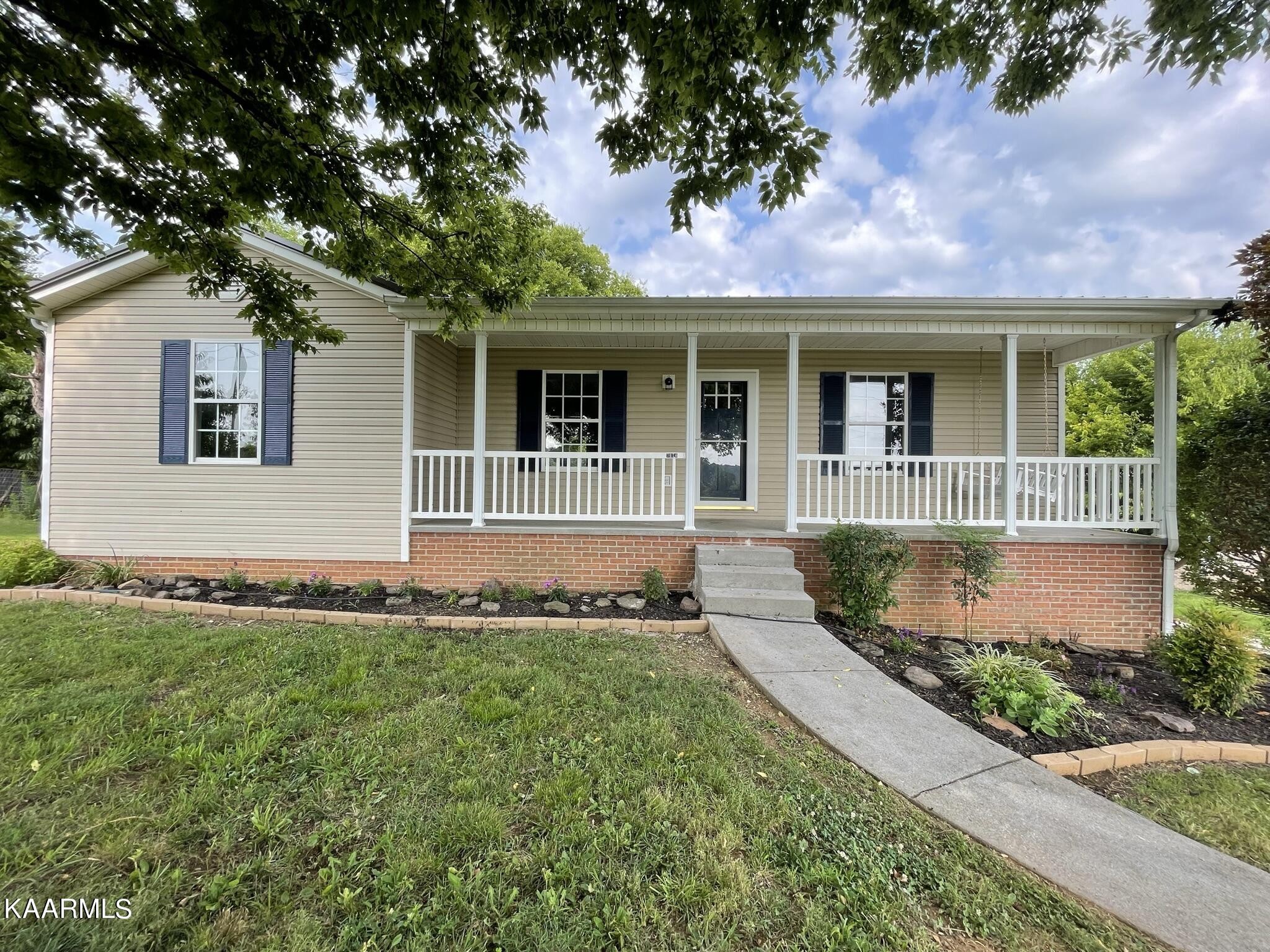 7170 Cedar Hill Road Talbott, TN 37877 - Photo 1 of 27 a front view of a house with a yard