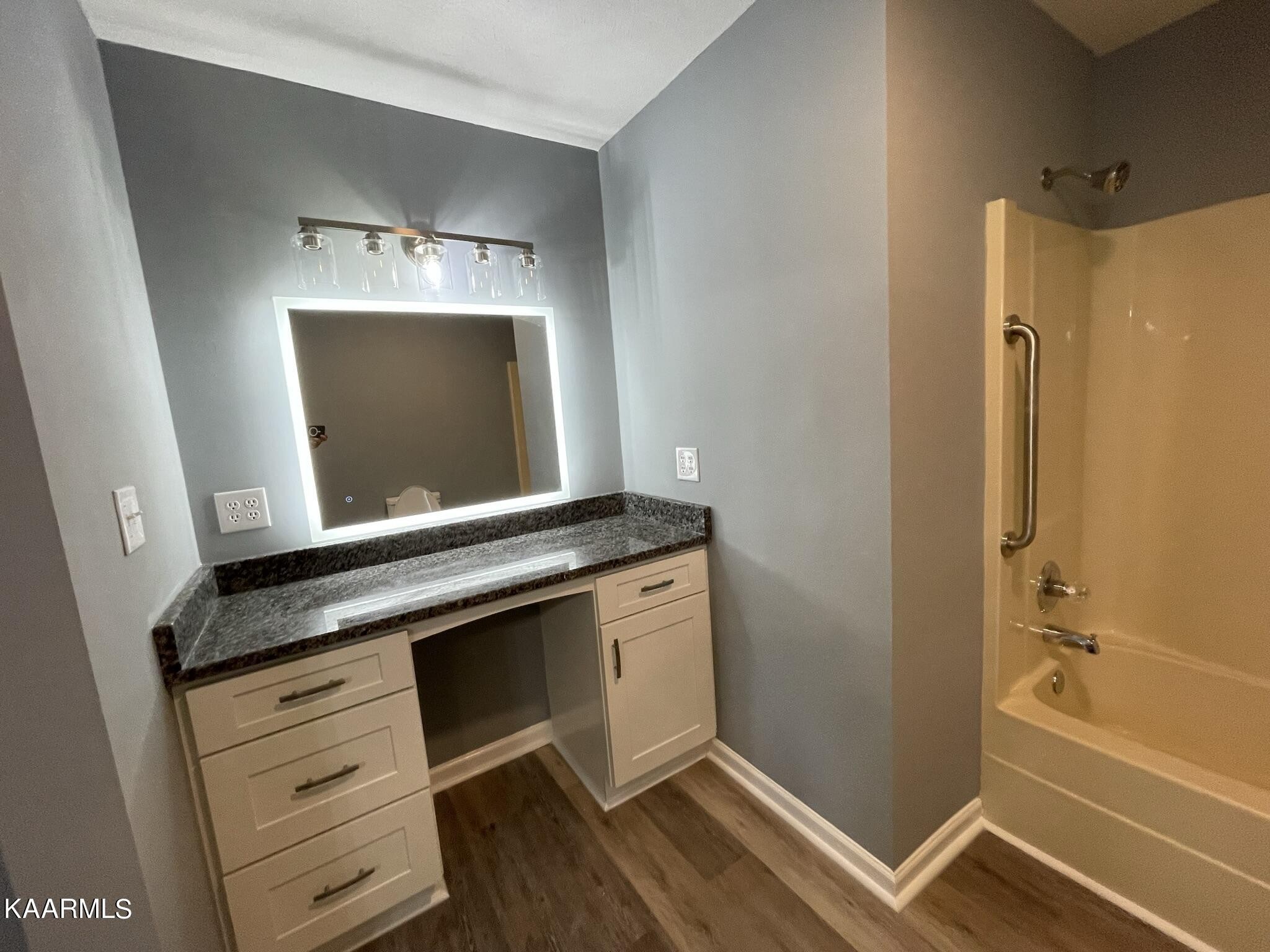 7170 Cedar Hill Road Talbott, TN 37877 - Photo 13 of 27 a bathroom with a granite countertop sink a mirror and a bathtub