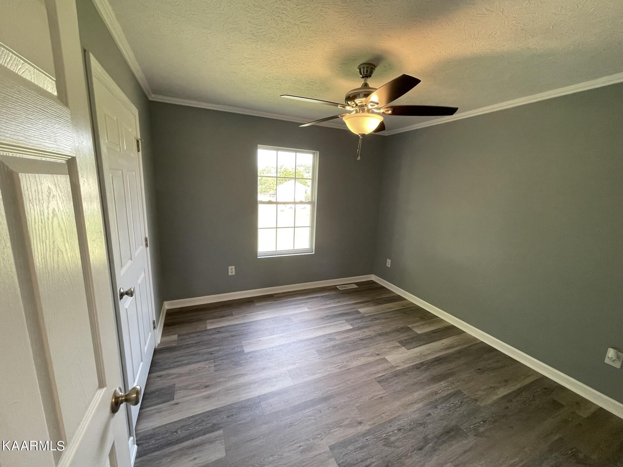 7170 Cedar Hill Road Talbott, TN 37877 - Photo 15 of 27 an empty room with wooden floor fan and window