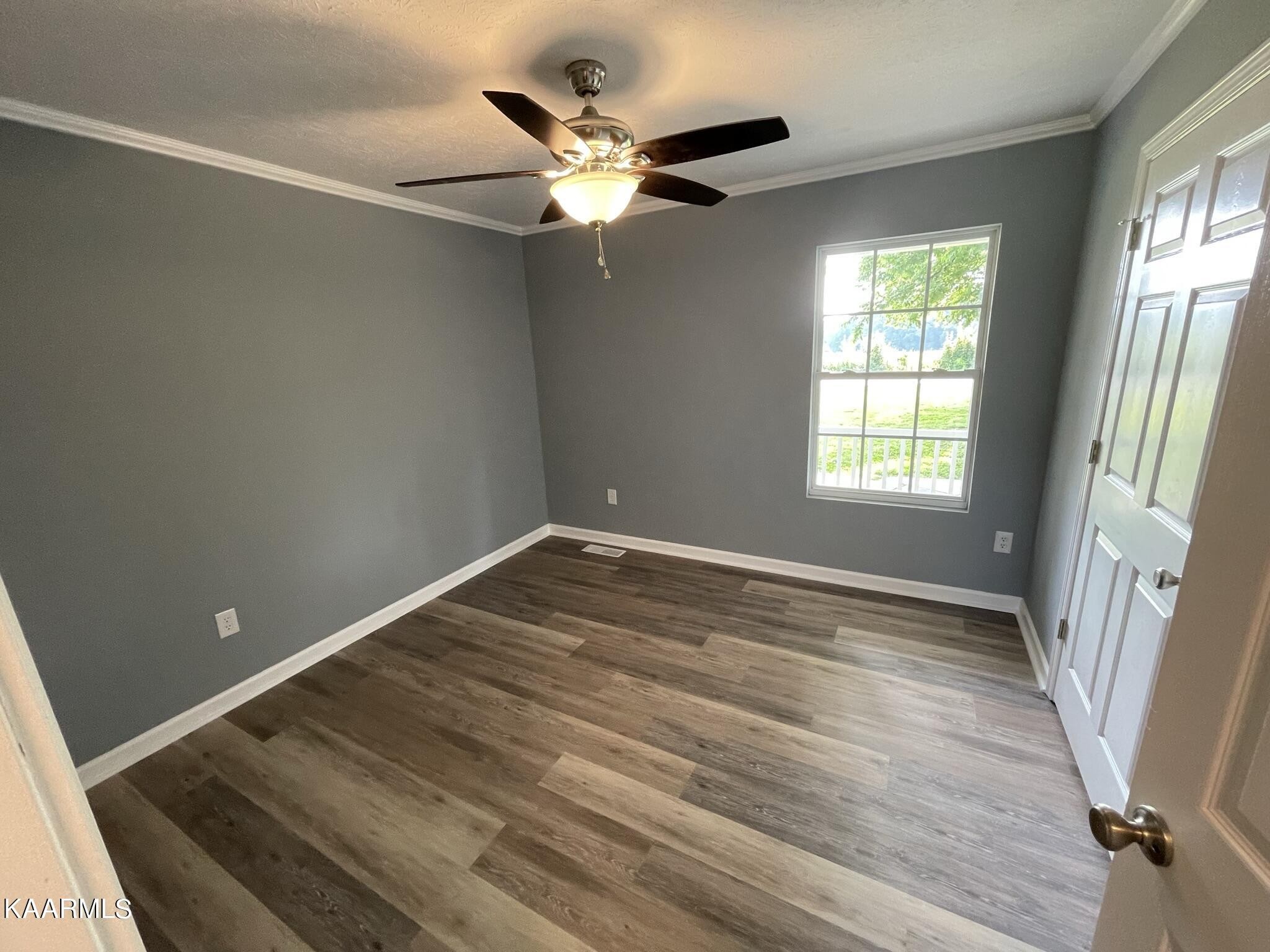 7170 Cedar Hill Road Talbott, TN 37877 - Photo 17 of 27 an empty room with wooden floor fan and windows