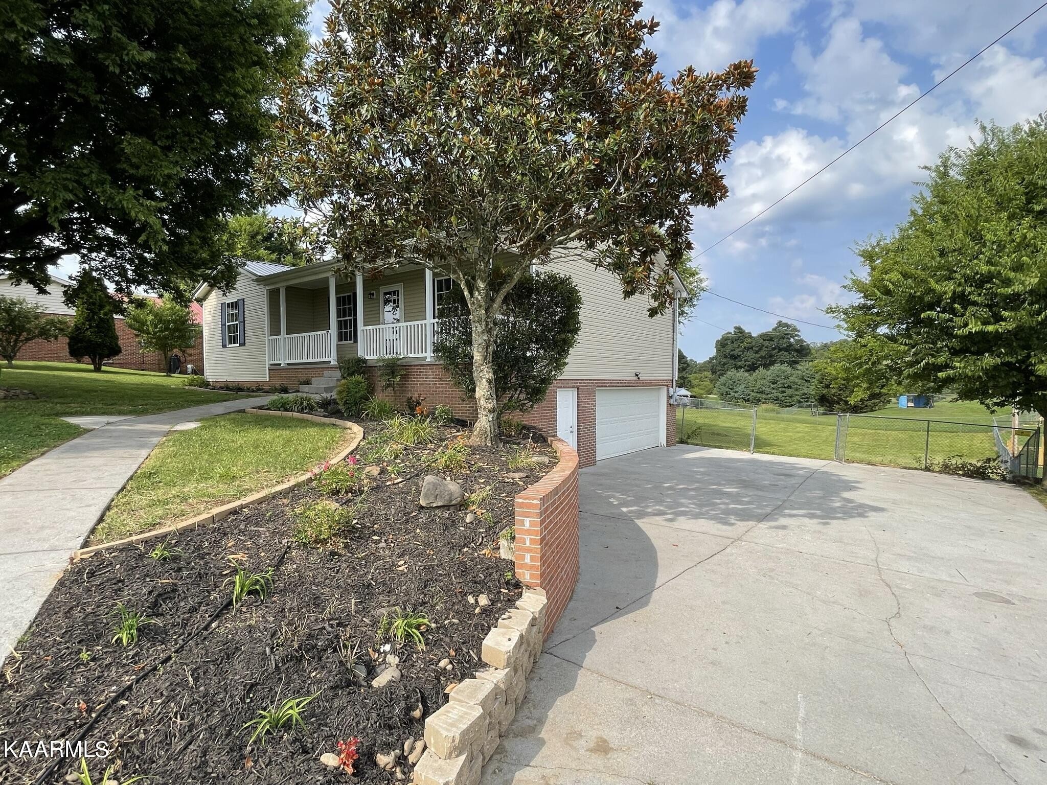 7170 Cedar Hill Road Talbott, TN 37877 - Photo 23 of 27 a view of a house with a yard and large tree