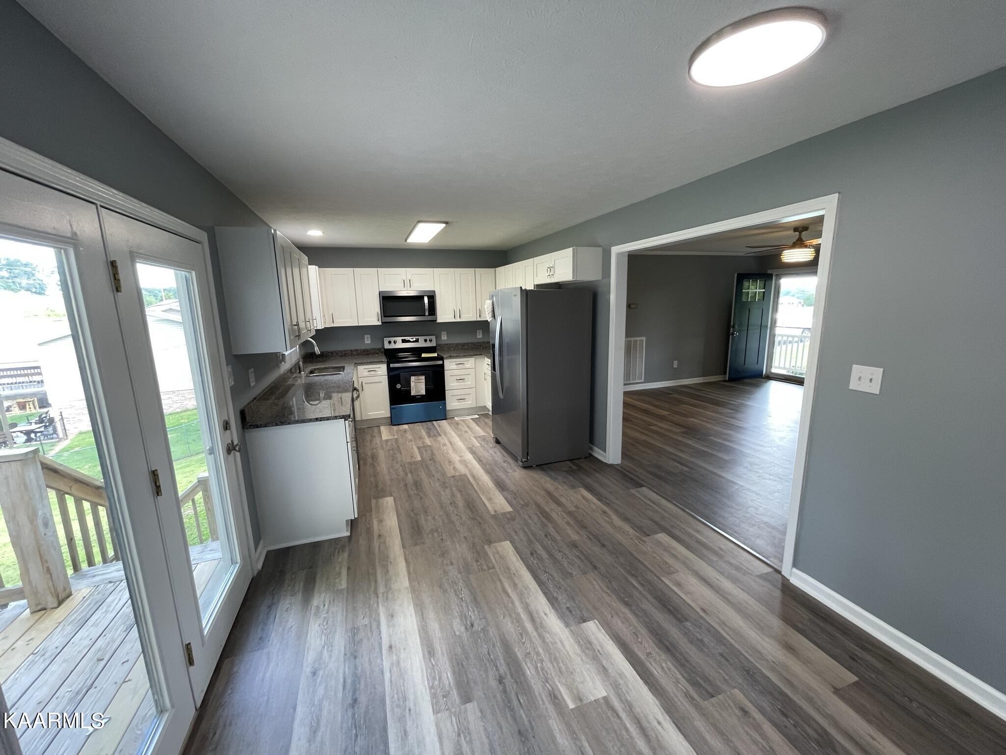 7170 Cedar Hill Road Talbott, TN 37877 - Photo 3 of 27 a view of a kitchen with wooden floor and a window
