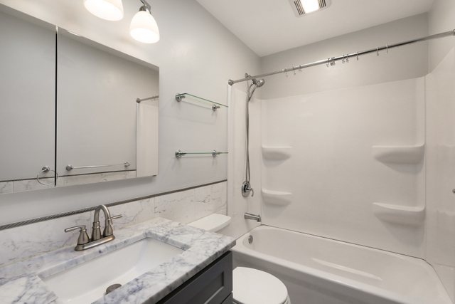 2394 Elm Road West Chicago, IL 60185 - Photo 12 of 28 a bathroom with a granite countertop sink toilet and shower