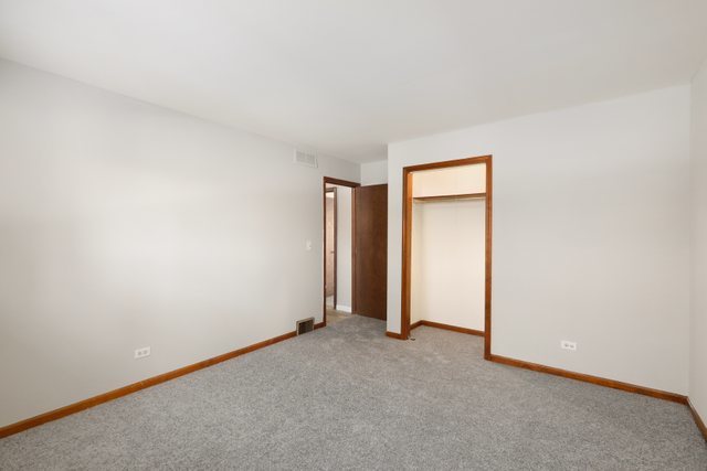 2394 Elm Road West Chicago, IL 60185 - Photo 14 of 28 an empty room with closet and a window