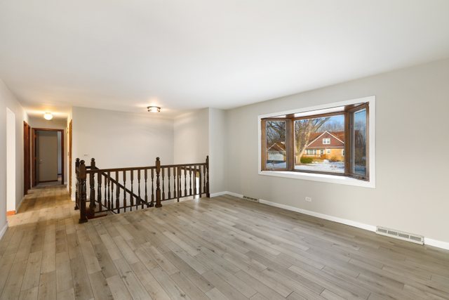 2394 Elm Road West Chicago, IL 60185 - Photo 2 of 28 an empty room with wooden floor and windows