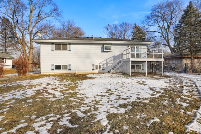 2394 Elm Road West Chicago, IL 60185 - Photo 26 of 28 a front view of a house with a yard covered with snow and trees