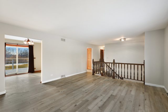 2394 Elm Road West Chicago, IL 60185 - Photo 3 of 28 an empty room with wooden floor and windows