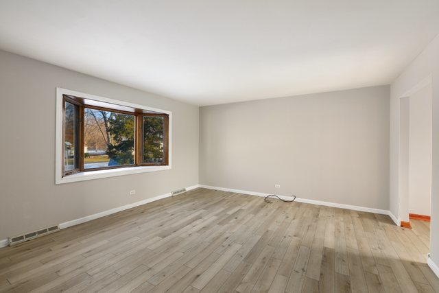 2394 Elm Road West Chicago, IL 60185 - Photo 4 of 28 an empty room with wooden floor and windows