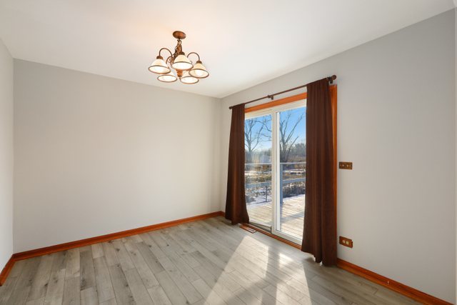 2394 Elm Road West Chicago, IL 60185 - Photo 7 of 28 wooden floor in an empty room with a window