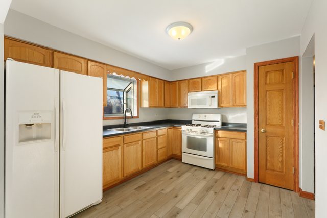 2394 Elm Road West Chicago, IL 60185 - Photo 8 of 28 a kitchen with stainless steel appliances granite countertop a refrigerator a sink dishwasher and a stove with wooden floor