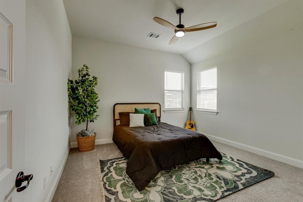 9613 Boulder Pt Road Oak Point, TX 75068 - Photo 28 of 28 Carpeted room featuring a vaulted ceiling and a ceiling fan with integrated lighting