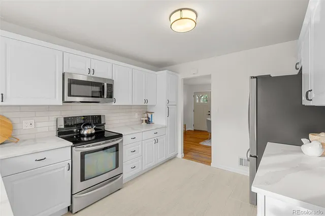 a kitchen with a sink stove and refrigerator