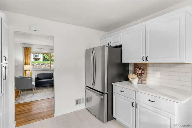 a kitchen with stainless steel appliances a refrigerator sink and cabinets