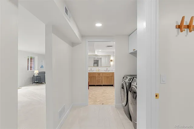 a spacious bathroom with a double vanity sink and a mirror