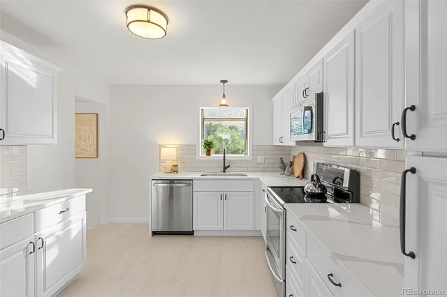 a kitchen with a sink stove and cabinets