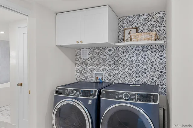 a view of a patio with table and chairs with wooden fence and plants
