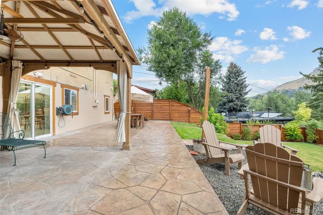 a view of a patio with table and chairs and potted plants