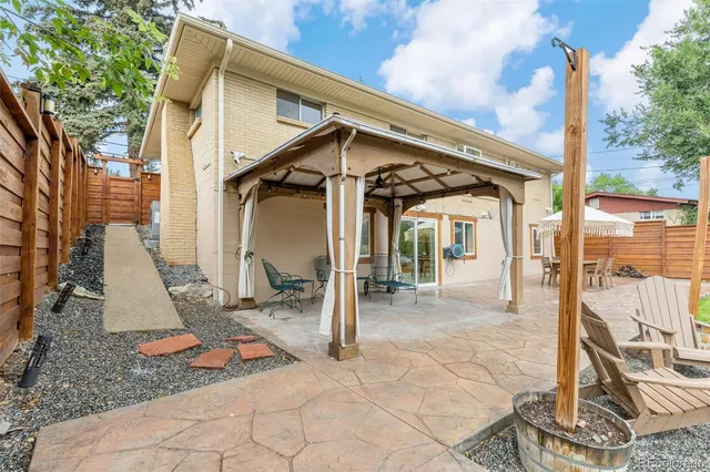 a backyard of a house with fountain and barbeque oven