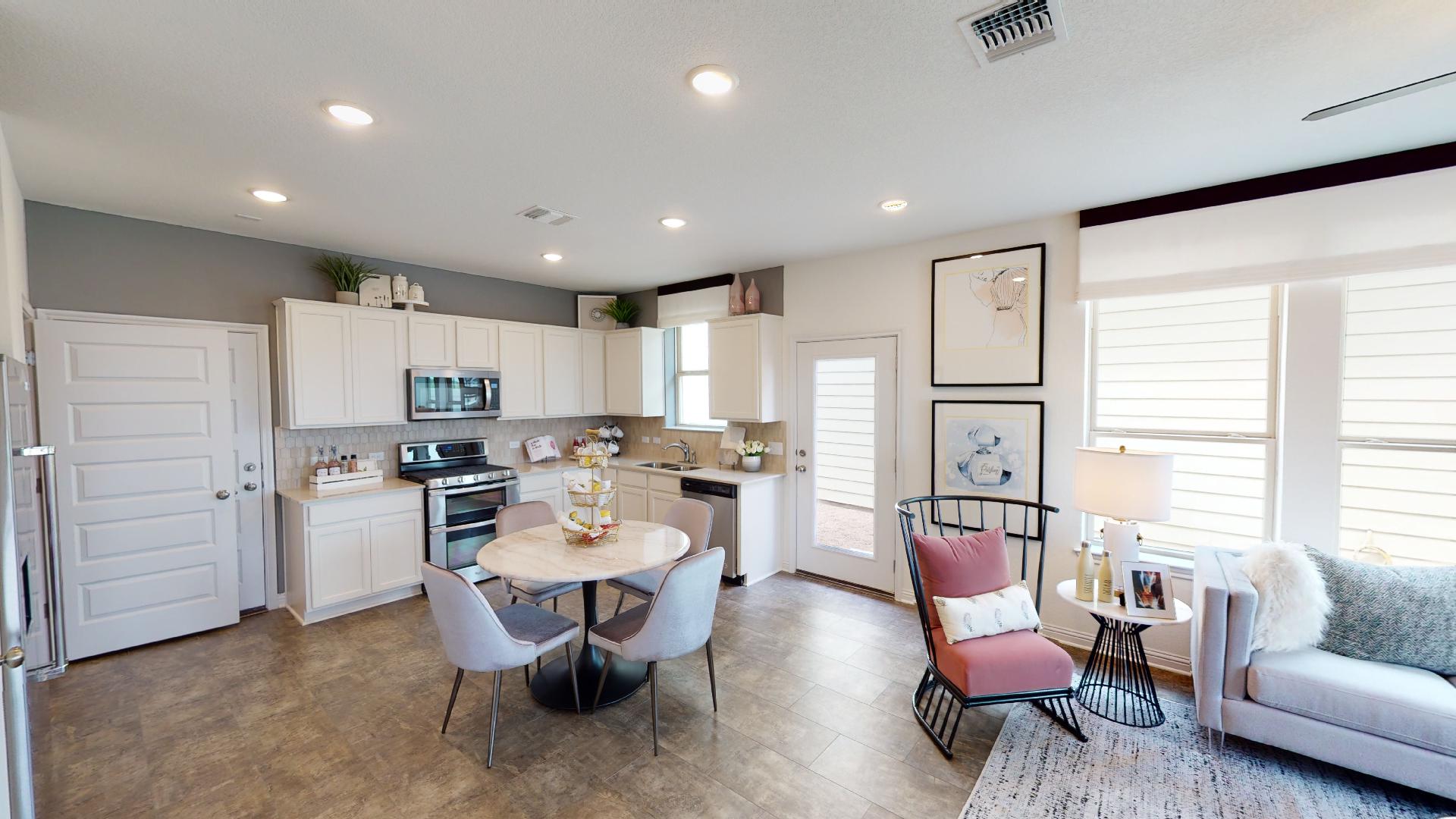 8200 Springsteen Drive Austin, TX 78744 - Photo 4 of 10 Kitchen with light countertops, stainless steel appliances, white cabinets, tasteful backsplash, and recessed lighting