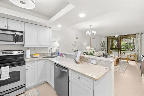 a view of a kitchen with a sink stainless steel appliances and cabinets