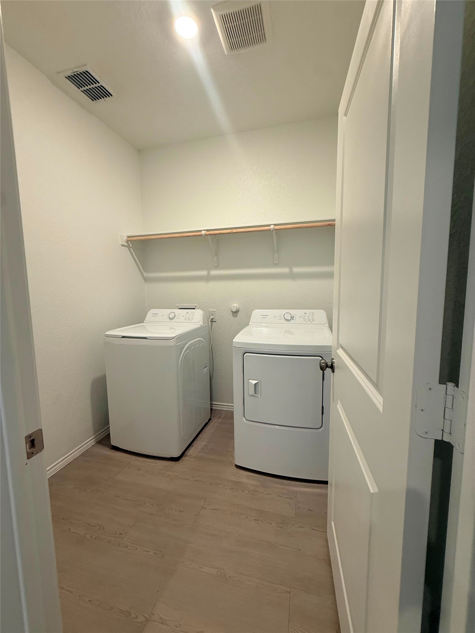 192 Rodney Boat Road Kyle, TX 78640 - Photo 7 of 40 Functional laundry room equipped with a washer and dryer, complete with convenient shelving.