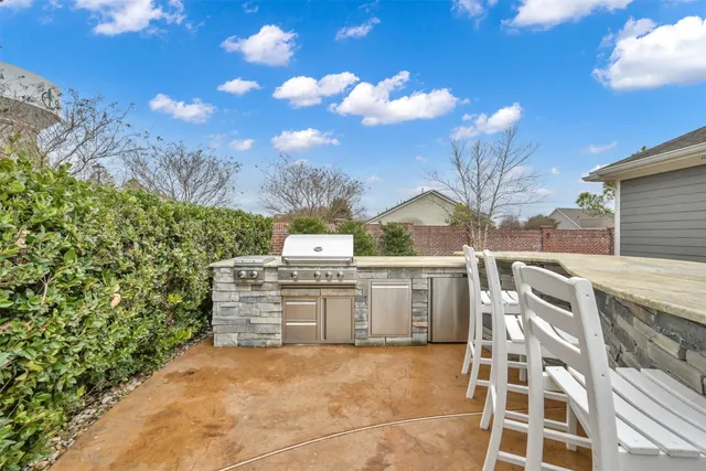 a living room with patio furniture and a flat screen tv