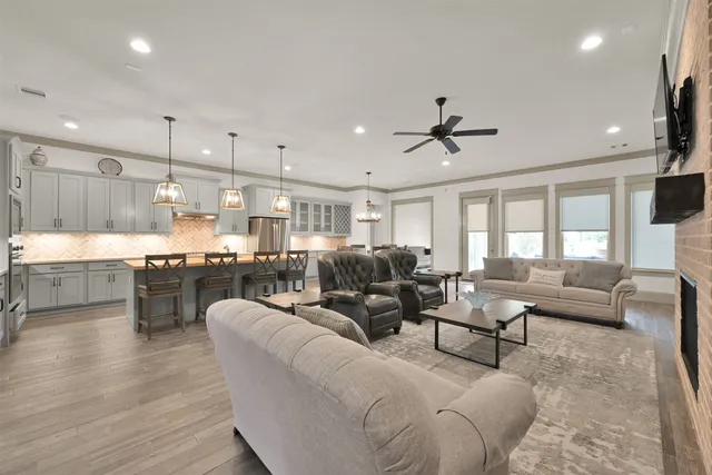 a living room with furniture kitchen and a chandelier