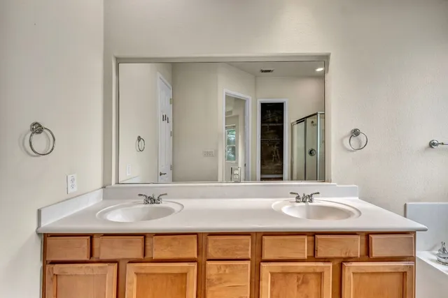 a bathroom with a sink double vanity and a mirror