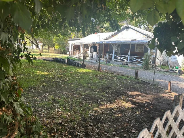 a view of a house with a yard and sitting area
