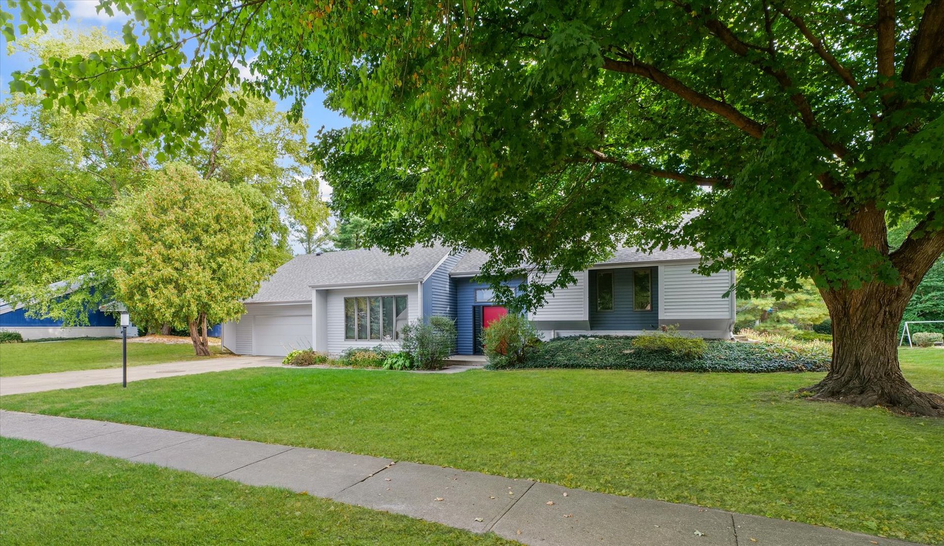 a front view of house with yard and green space