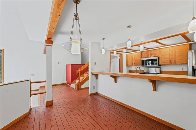 a living room with wooden floor and a sink