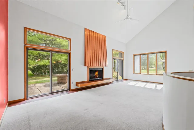 an empty room with fireplace and windows