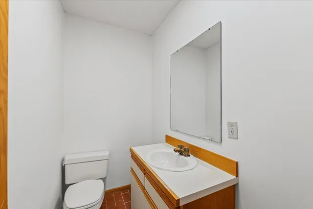 a bathroom with a toilet sink and mirror