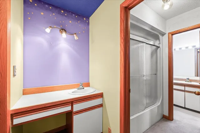 a bathroom with a sink and a mirror