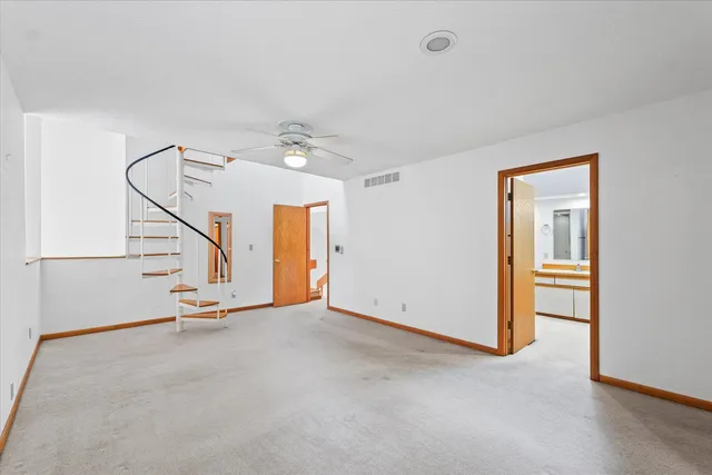a view of an empty room with stairs