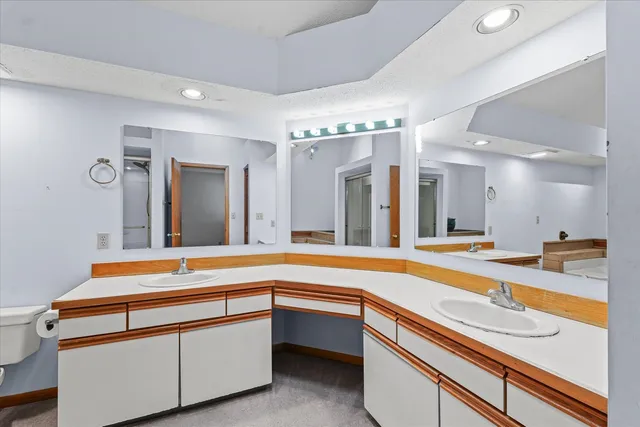 a spacious bathroom with a sink and mirror