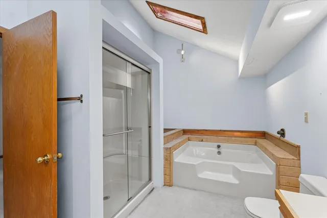 a bathroom with a tub and toilet