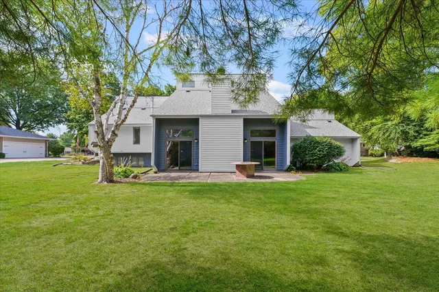 a view of a house with a yard and sitting area