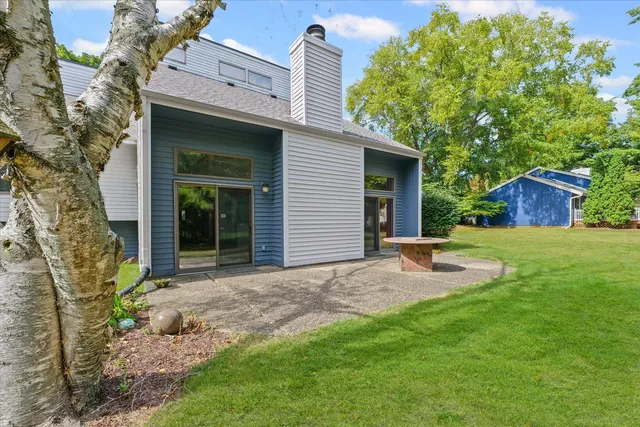 a view of a house with a yard and tree