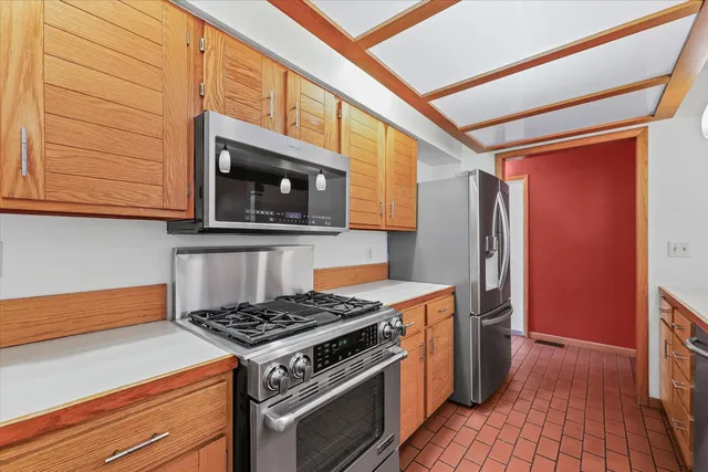 a kitchen with stainless steel appliances granite countertop a stove and a refrigerator