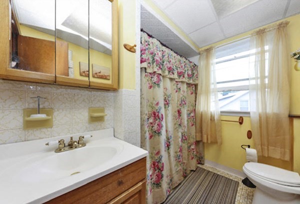60 Baker Road Everett, MA 02149 - Photo 17 of 27 a bathroom with a sink a toilet and a shower curtain
