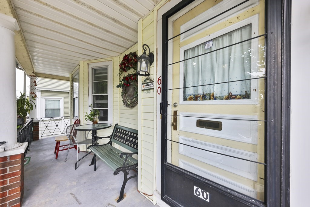 60 Baker Road Everett, MA 02149 - Photo 2 of 27 a view of a patio with table and chairs and couches with wooden floor