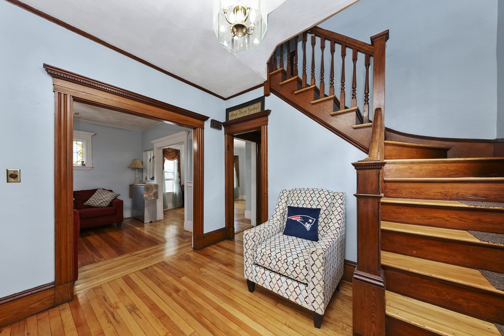60 Baker Road Everett, MA 02149 - Photo 4 of 27 a view of staircase with wooden floor and a rug