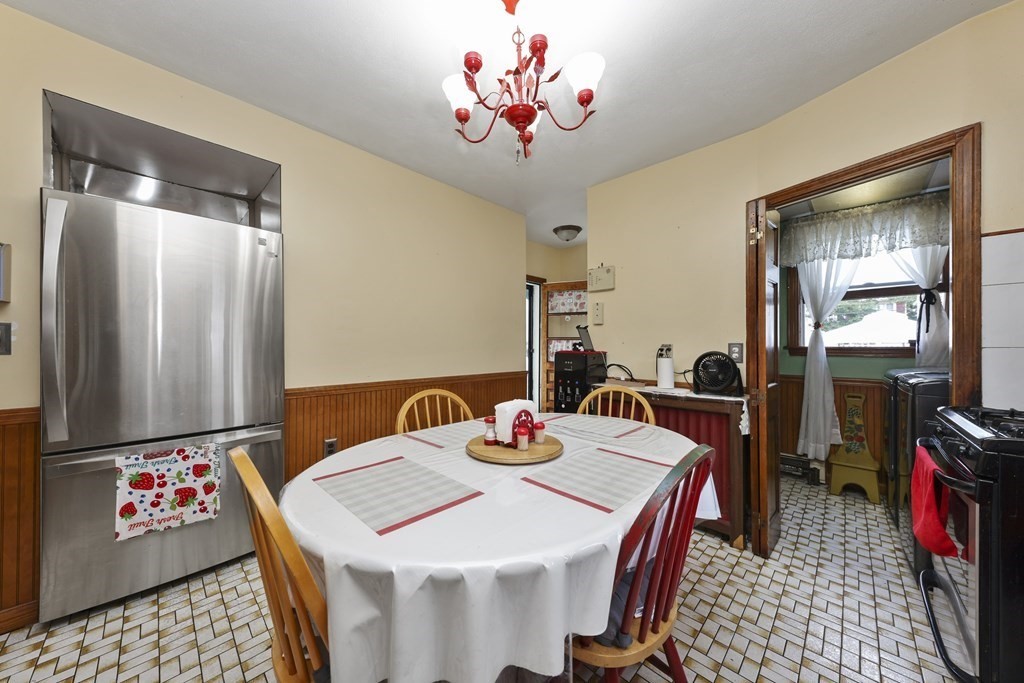 60 Baker Road Everett, MA 02149 - Photo 9 of 27 a view of a dining room with furniture and wooden floor
