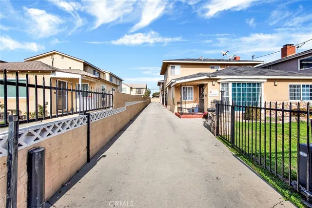 a view of a house with wooden fence