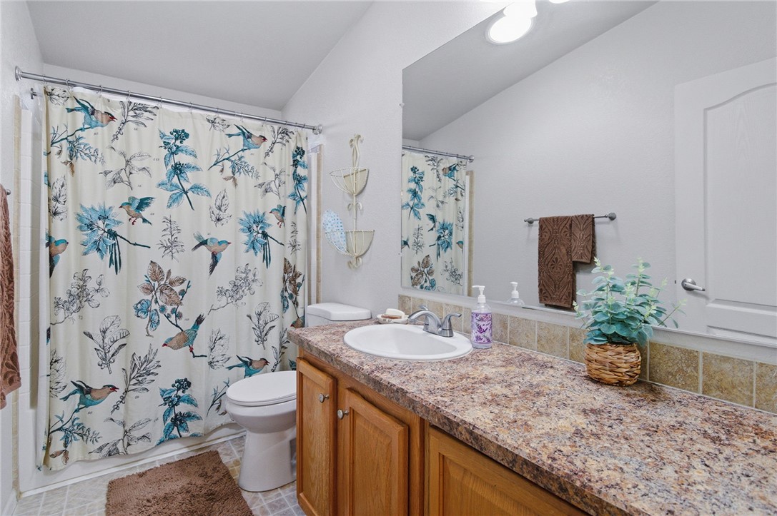 4342 Cordes Road Golden Valley, AZ 86413 - Photo 28 of 39 a bathroom with a granite countertop sink and a mirror